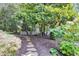 Beautiful backyard with stone pathway, mature trees, manicured landscaping, and a white picket fence at 510 Elgaen Ct, Roswell, GA 30075