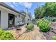 Enjoy this home's outdoor space, featuring a stone patio, manicured landscaping, and a charming white picket fence at 510 Elgaen Ct, Roswell, GA 30075