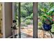 Step outside to the backyard and enjoy a charming stone patio surrounded by beautiful greenery and lush landscaping at 510 Elgaen Ct, Roswell, GA 30075