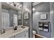 Bathroom featuring gray walls, a white vanity, an oval sink, an decorative light fixture and matching gray towels at 510 Elgaen Ct, Roswell, GA 30075