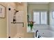 Spa-like bathroom featuring a glass-enclosed shower and a luxurious soaking tub by the window at 510 Elgaen Ct, Roswell, GA 30075
