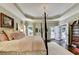 Bedroom features tray ceilings, hardwood floors, and french doors to the outside at 510 Elgaen Ct, Roswell, GA 30075
