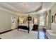 Main bedroom with a tray ceiling, four-poster bed, and bright floral draperies at 510 Elgaen Ct, Roswell, GA 30075