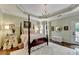Spacious bedroom features a four-poster bed, tray ceilings, and access to the outdoors at 510 Elgaen Ct, Roswell, GA 30075