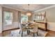 Elegant dining room featuring a round table, chandelier, and wainscoting at 510 Elgaen Ct, Roswell, GA 30075