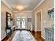Elegant foyer features hardwood floors, double doors, and decorative console table with floral arrangement at 510 Elgaen Ct, Roswell, GA 30075