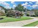 Inviting brick home with landscaped front yard and a two-car garage, set under a partly cloudy sky at 510 Elgaen Ct, Roswell, GA 30075