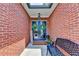 Inviting front porch with double doors, brick facade, and decorative wreaths and bench at 510 Elgaen Ct, Roswell, GA 30075