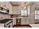 Bright kitchen featuring stainless steel appliances, white cabinets, and modern lighting at 510 Elgaen Ct, Roswell, GA 30075