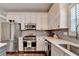 Bright kitchen featuring stainless steel appliances, white cabinets, and modern lighting at 510 Elgaen Ct, Roswell, GA 30075