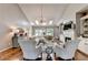 Spacious living room with tall ceilings, hardwood floors, a fireplace, and elegant decor at 510 Elgaen Ct, Roswell, GA 30075