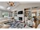 Bright living room features vaulted ceiling, skylight, fireplace, and built-in shelving at 510 Elgaen Ct, Roswell, GA 30075