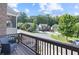 Balcony with a view of a quiet street lined with well-maintained houses and lush trees at 5504 Cameron Parc Dr, Alpharetta, GA 30022