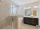 Bright bathroom featuring a shower with glass door, soaking tub, and a dual sink vanity at 5504 Cameron Parc Dr, Alpharetta, GA 30022