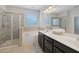Bright bathroom features double vanity, soaking tub, and glass-enclosed shower at 5504 Cameron Parc Dr, Alpharetta, GA 30022