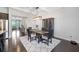 Bright dining room with dark wood table, a modern chandelier, and a decorative cabinet at 5504 Cameron Parc Dr, Alpharetta, GA 30022