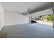 Spacious two-car garage with an open door and a clean, painted floor, offering ample parking at 5504 Cameron Parc Dr, Alpharetta, GA 30022