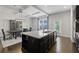 Kitchen with an island, granite countertops, stainless steel appliances and coffered ceiling looking to dining at 5504 Cameron Parc Dr, Alpharetta, GA 30022