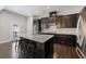 Spacious kitchen with a large island, granite counters, stainless steel appliances, and dark wood cabinets at 5504 Cameron Parc Dr, Alpharetta, GA 30022