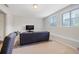 Basement living room with large windows, carpeting, and a comfortable couch at 5504 Cameron Parc Dr, Alpharetta, GA 30022