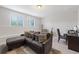 Inviting living room featuring a comfortable couch, neutral walls, and natural light from the windows at 5504 Cameron Parc Dr, Alpharetta, GA 30022