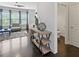 Stylish living room with hardwood floors, modern console, and half bath creating an inviting space for relaxation at 5504 Cameron Parc Dr, Alpharetta, GA 30022