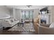 Open living room with fireplace, large windows, hardwood floors and comfortable seating creating a welcoming space at 5504 Cameron Parc Dr, Alpharetta, GA 30022