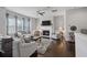 Bright living room with fireplace, ceiling fan, hardwood floors and comfortable seating creating a cozy atmosphere at 5504 Cameron Parc Dr, Alpharetta, GA 30022