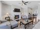 Spacious living room with fireplace, ceiling fan, hardwood floors, and stylish decor creating a relaxing retreat at 5504 Cameron Parc Dr, Alpharetta, GA 30022