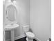 Elegant powder room with a pedestal sink, stylish fixtures, and a clean, modern aesthetic at 5504 Cameron Parc Dr, Alpharetta, GA 30022