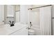 This bathroom has white features with black fixtures and a shower and bathtub combination at 704 Banton Nw Dr, Atlanta, GA 30318