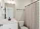 Clean bathroom featuring modern vanity, mirror, and stylish striped shower curtain at 704 Banton Nw Dr, Atlanta, GA 30318