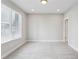Serene room with soft carpet, large window with blinds, and neutral wall color at 704 Banton Nw Dr, Atlanta, GA 30318