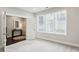Bright bedroom with soft carpet, large windows, and adjacent room entrance at 704 Banton Nw Dr, Atlanta, GA 30318