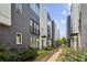 View of modern townhomes with well-maintained landscaping and a pathway at 704 Banton Nw Dr, Atlanta, GA 30318