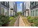 Charming brick pathway through a residential community with modern townhomes and lush greenery at 704 Banton Nw Dr, Atlanta, GA 30318