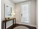 Inviting foyer with stylish console table, mirror, and door with privacy blinds at 704 Banton Nw Dr, Atlanta, GA 30318
