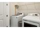 This laundry room features a modern washer and dryer with wire racks for storage at 704 Banton Nw Dr, Atlanta, GA 30318