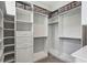 This walk-in closet has adjustable shelving, drawers, and custom storage for optimal organization at 704 Banton Nw Dr, Atlanta, GA 30318