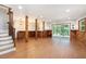 Finished basement features wood paneled walls, bar area, and sliding glass door at 9025 Huntcliff Trce, Atlanta, GA 30350