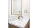 Modern bathroom featuring a new vanity with quartz countertops and lighted mirror at 9025 Huntcliff Trce, Atlanta, GA 30350