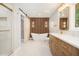 Modern bathroom featuring a standalone tub, stylish lighting, and a glass-enclosed shower at 9025 Huntcliff Trce, Atlanta, GA 30350