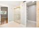 Bathroom featuring glass shower and a closet, with tile flooring and modern fixtures at 9025 Huntcliff Trce, Atlanta, GA 30350