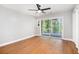 Comfortable bedroom with laminate floors, ceiling fan, and sliding doors to screened-in porch at 9025 Huntcliff Trce, Atlanta, GA 30350