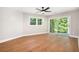Well-lit bedroom with laminate floors, large windows, and access to outdoor space at 9025 Huntcliff Trce, Atlanta, GA 30350