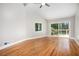 Bright bedroom with hardwood floors and sliding doors to a deck at 9025 Huntcliff Trce, Atlanta, GA 30350