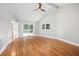 Bright bedroom with vaulted ceiling, ceiling fan, hardwood floors, and sliding glass door at 9025 Huntcliff Trce, Atlanta, GA 30350