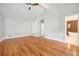 Large primary bedroom with hardwood floors leading to a luxurious ensuite bathroom at 9025 Huntcliff Trce, Atlanta, GA 30350