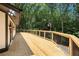 Spacious wooden deck surrounded by lush greenery offers serene outdoor living space at 9025 Huntcliff Trce, Atlanta, GA 30350