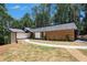 Beautiful exterior elevation with stone and manicured lawn at 9025 Huntcliff Trce, Atlanta, GA 30350